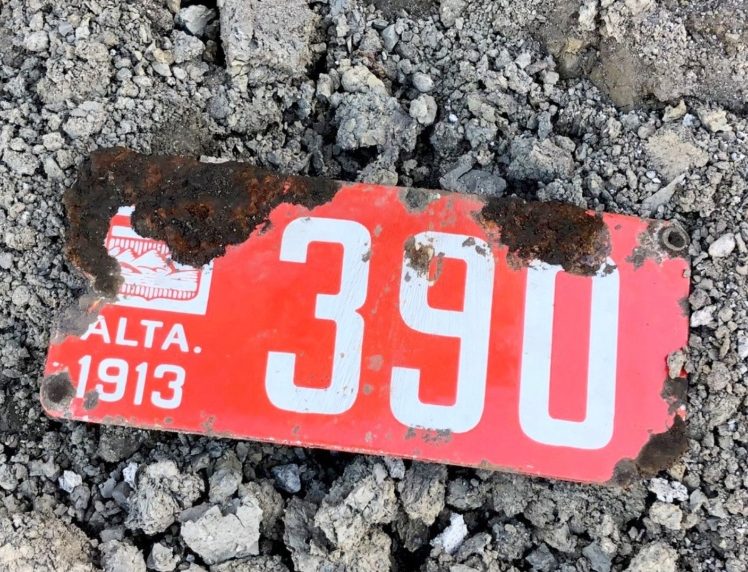 Alberta licence plate from 1913 in gravel